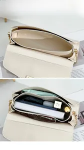 Detail of creamy white pebble leather crossbody bag with dual compartments and chain