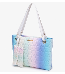 Detail of gradient heart-quilted tote bag and mini pouch with golden hardware clips