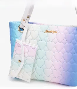 Detail of gradient heart-quilted tote bag featuring rainbow pastel colors and golden hardware