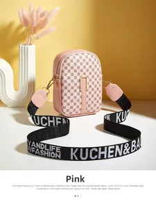 Detailed macro view of pink PU leather mini crossbody bag with dot patterns on yellow background