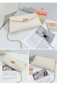 Detail showing creamy white litchi grain leather texture and gold chain on envelope bag