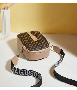 Detail of printed crossbody phone bag with wide lettered strap and beige faux leather finish