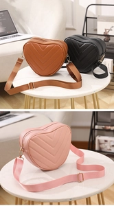 Detail of heart-shaped quilted crossbody bag with adjustable strap and gold hardware