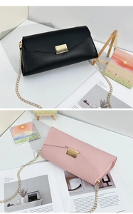Detail of pink and black envelope chain bags with lychee grain texture and gold buckles