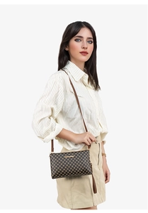 Detail of crossbody bag featuring brown dot pattern, gold metal logo, and leather strap