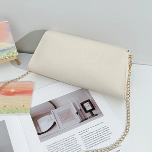 Minimalist beige pebble leather envelope chain crossbody bag on an aesthetic desktop