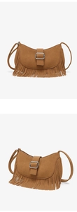 Detail of a brown suede hobo bag with vintage tassels and a silver square metal buckle