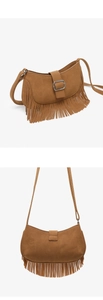 Detail of brown suede tassel shoulder bag with a silver buckle and adjustable strap