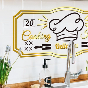 Kitchen wall sticker with golden chef hat and Cooking Delicious text on white tile wall