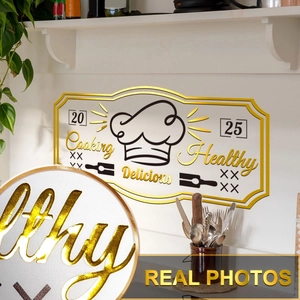 Detail of 3D gold embossed chef hat wall sign with Cooking Healthy Delicious text