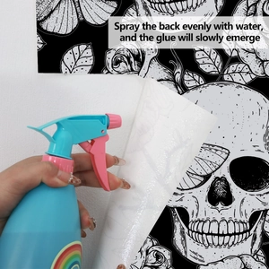 Water spray application on Halloween skull wallpaper with butterfly and rose pattern