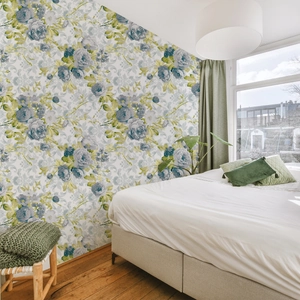 Elegant floral wallpaper with blue roses and yellow leaves in a bedroom setting