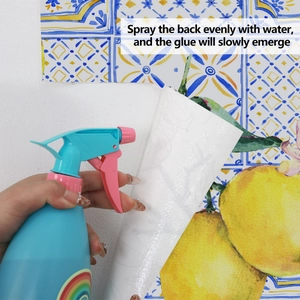 Detail of water-activated adhesive wallpaper with lemon and blue tile pattern