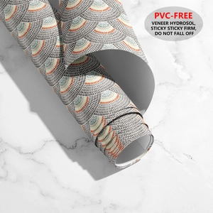 Detail of vintage scallop pattern wallpaper roll showing self-adhesive PVC-free backing