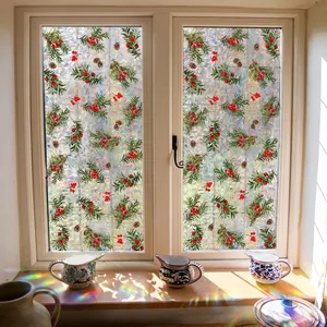 Christmas window film with red berries and pine cones creating rainbow prism light effects