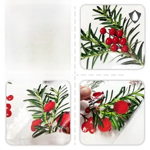 Detail of Christmas red berries window film showing front side and waterproof texture