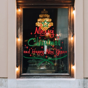 Christmas window decals with Merry Christmas text and stars on a cozy glass pane