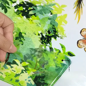 Detail showing the removable adhesive backing of green leaf wall stickers for children's rooms