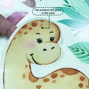 Detail of glow in the dark cartoon giraffe wall sticker being peeled for room decor