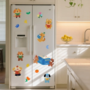 Detailed view of cute cartoon animals reading books on a white refrigerator surface
