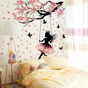 Pink cherry blossom branch wall decal with a girl on a swing for girl's bedroom decoration
