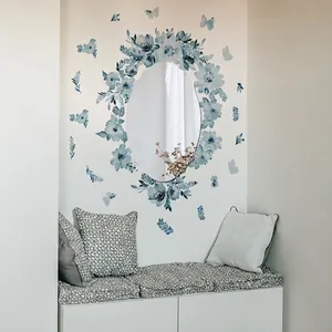 Blue watercolor floral wall stickers and butterfly decals surrounding an oval mirror