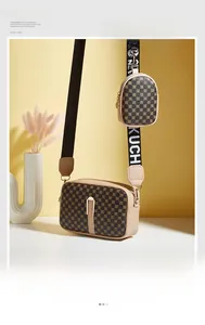 Detail view of cream camera bag set with vintage geometric pattern and woven letter strap