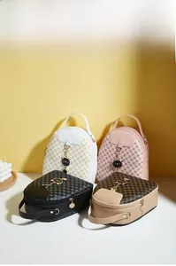 Close-up of quilted mini backpacks with golden cat charms in multiple colors