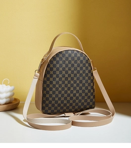 Detail of a mini khaki and brown patterned shoulder bag with gold hardware in an artistic setting