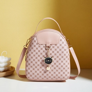 Pink PU leather mini crossbody bag with geometric floral print and cute black cat charm