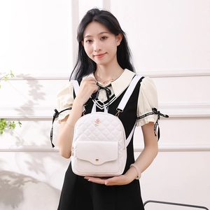 White quilted mini backpack with rose embroidery and adjustable straps for women