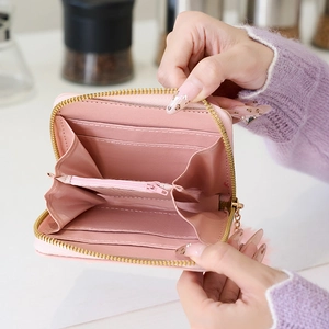 Pink polka dot mini wallet with card slots and a cute faux fur pompom keychain pendant