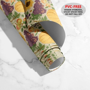 Detail of vintage fruit and flower wallpaper roll showing adhesive backing and PVC-free texture