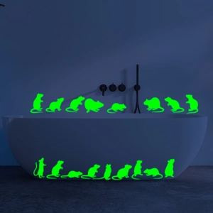 Luminous green mouse wall stickers glowing on a bathtub in a dark bathroom setting