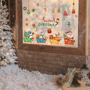 Festive Christmas window decals featuring Santa, snowman and reindeer on glass pane