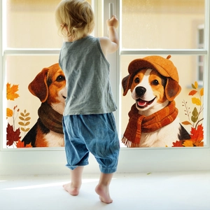 Detail of cute puppy window decals with autumn maple leaves on bright glass surface