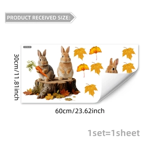 Detail of autumn window decals featuring realistic rabbits and fallen maple leaves