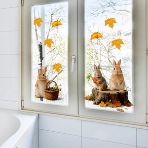Detail of realistic rabbit window clings with autumn maple leaves on glass surface