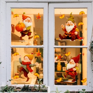 Detail of autumn gnome window decals featuring pumpkins and colorful maple leaves