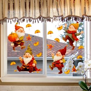 Detail of autumn gnome window clings featuring pumpkins and maple leaves on glass