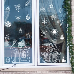 White line drawing Christmas house window decals with snowflakes and holiday decorations