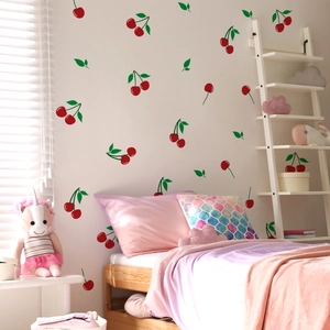 Nursery wall decorated with hand-painted red cherry stickers and green leaf decals