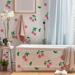 Detail of pink cherry wall stickers applied on bathroom tiles and bathtub surface