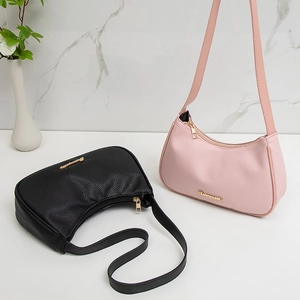 Lychee pattern faux leather underarm bags in black and pink with gold logo and shoulder straps