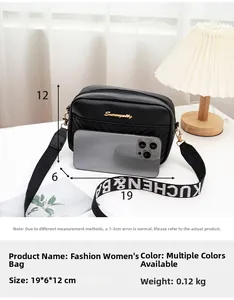 Detail of black crossbody bag showing V-pattern stitching and 19x6x12cm dimensions