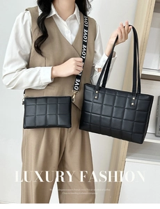 Detail of black quilted tote bag and matching crossbody bag with LOVE webbing strap