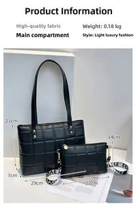 Detail of black quilted tote bag set featuring wide LOVE strap and gold rivet accents