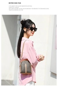 Detail of vintage bucket bag with geometric print and leather shoulder strap on model