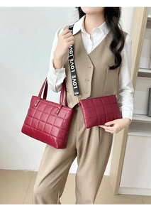 Detail view of burgundy quilted tote and crossbody bag set with LOVE logo strap