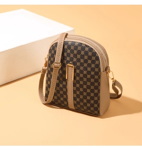 Detailed side view of mini crossbody bag with floral jacquard and triple zippers